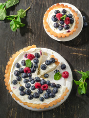 Tarts with berries and whipped cream.
