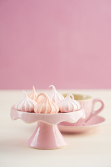 Tea time with pastels colored meringue kisses confectionary
