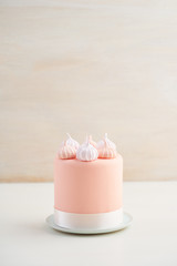 Mini fondant covered cake with meringue kisses