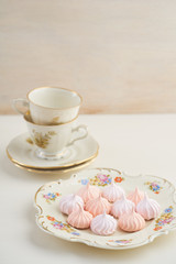 Tea time with pastels colored meringue kisses confectionary