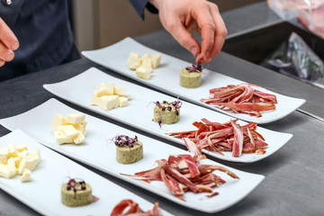 Male chef garnishing his dish
