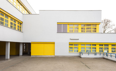 White Building Facade with Yellow Window Frames - obrazy, fototapety, plakaty