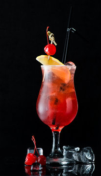 alcoholic cocktail on a dark background with reflection