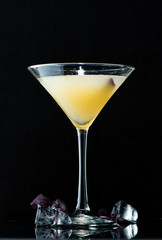 alcoholic cocktail on a dark background with reflection