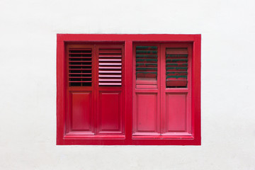 red window on white wall © boomks