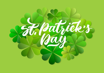 Concept of vector greeting card for St. Patrick's Day. White festive handwritten inscription on the background of green paper leaf clover.