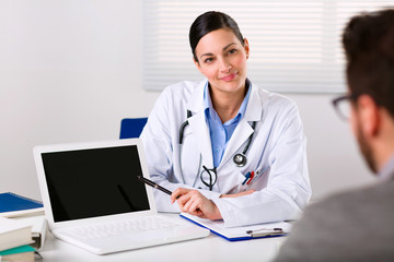 Fototapeta na wymiar Female doctor listening intently to a patient