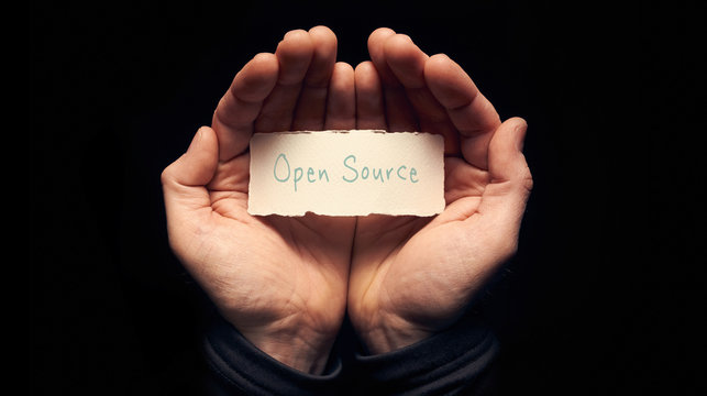 Hands holding a Open Source Concept