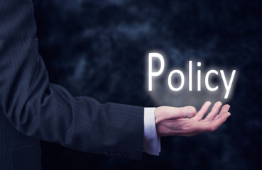 Hand holding a Policy Concept