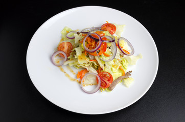 Thai salad with beef and vegetables on a white plate