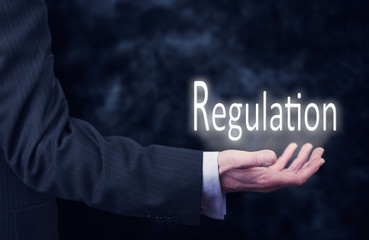 Hand holding a Regulation Concept