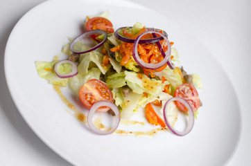 Thai salad with beef and vegetables on a white plate