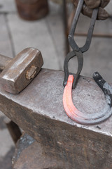 blacksmith makes horseshoe by tools