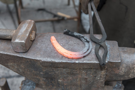 blacksmith makes horseshoe by tools