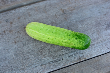 Cucumber, a healthy organic food ingredient, on a wooden surface