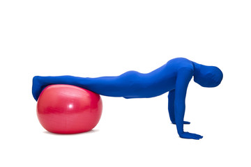 Mysterious blue man in morphsuit exercise with pilates  ball