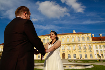 Groom and bride holding hands