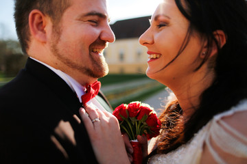 Portrait of a groom and bride kissing