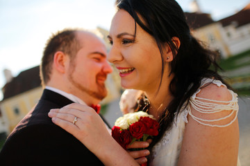 Portrait of a groom and bride kissing