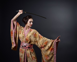  beautiful woman in traditional Japanese kimono with katana