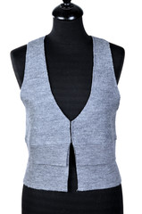 Woman's wear - sleeveless pullover. Knitted vest isolated on a white background, dressed on a mannequin