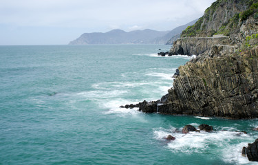 Long exposure moody dramatic seascape with rocks and motion blur