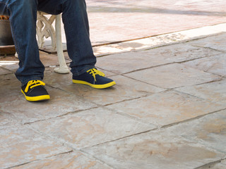 closeup man legs wear blue jeans pants and sneakers shoes space for text