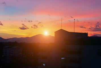 silhouette building   in city and sun sky  with color tone sunset, beautiful colorful evening nature landscape twilight time