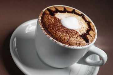 White cup of coffee with cream on top
