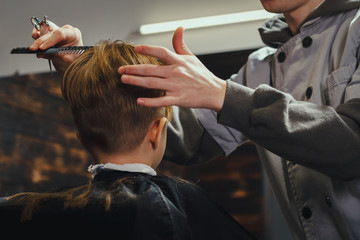 Little Boy Getting Haircut By Barber  