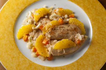 chicken breast with orange slices and vegetables