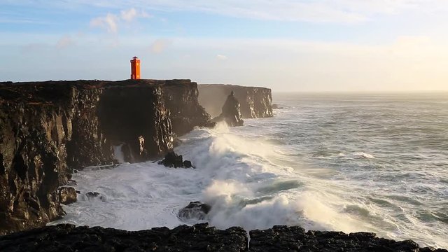 Waves breaking on the black rock cliff of western Icelandic coast, Snaefellsnes Peninsulain, Iceland
