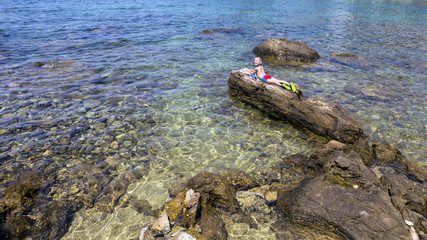 The boy relaxing on the beach.