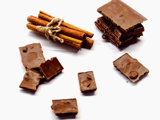 milk chocolate with cinnamon, raisins on white background