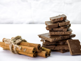 milk chocolate with cinnamon, raisins on white background