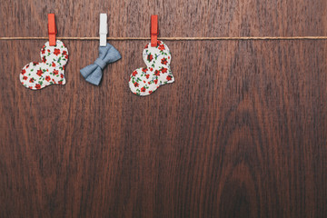 heart and bow tie attached clothespins on rope