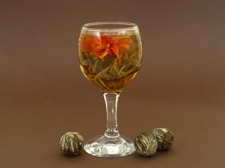 flowering tea or blooming tea on dark background