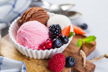 Selection of colorful ice cream scoops in white bowls