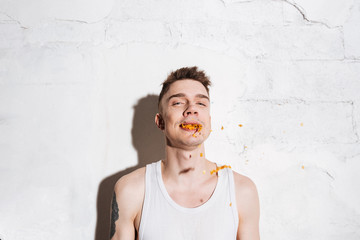 Portrait of man with potato chips in his mouth