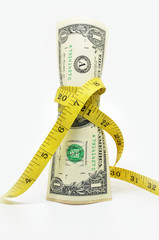 One dollars US money in measuring tape
