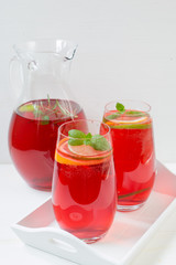 Fototapeta na wymiar Fresh red berry drink in glass. White background. Copy space.