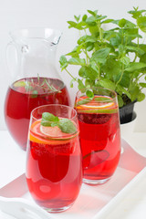Fototapeta na wymiar Fresh red berry drink in glass. White background. Copy space.