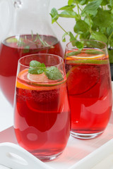 Fresh red berry drink in glass. White background. Copy space.