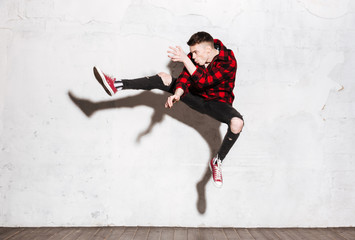 Fototapeta na wymiar Hipster in red shirt jumping