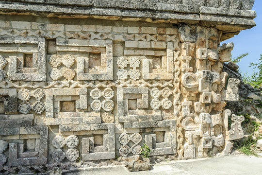 detail of the reliefs and large masks of the god Chaac of the temple of the big Mayan pyramid in the archaeological Uxmal enclosure in yucatan, Mexico