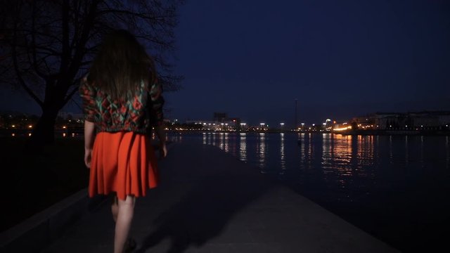 The girl in a red dress walking