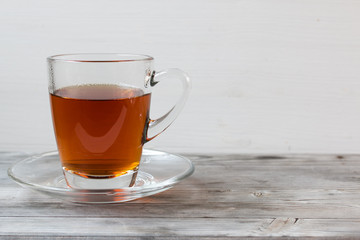 Black tea with mint. Grey wooden background.