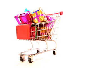 Shopping Cart with Christmas or New Year gifts boxes on isolated white