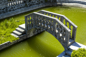 Stanjel, garden with stone bridge and water basin, Slovenia, Sou