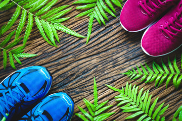 Fitness, healthy and active lifestyles lover Concept, male and female sport shoes on wooden background. copy space for text. Top view